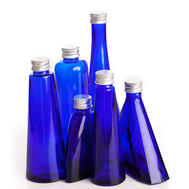 Little blue bottles isolated over white background - Zdjęcie, obraz