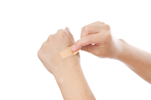 Bonding medicated plaster on woman's hand - Photo, image
