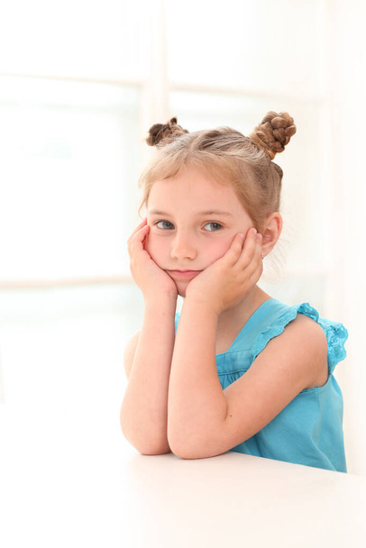 Cute little girl in blue dress at home - Фото, изображение