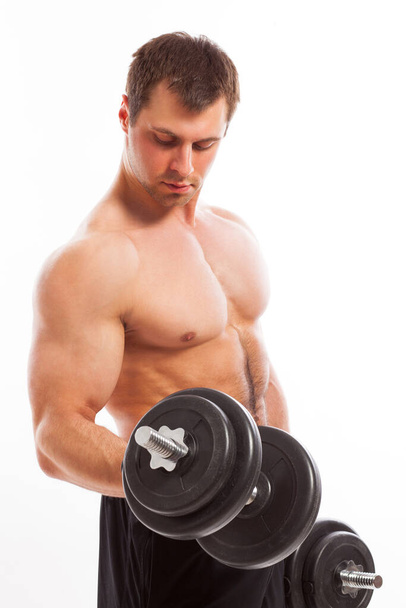 Handsome guy working out with dumbbells isolated over white background - Фото, зображення