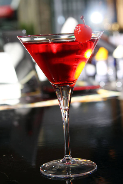 Pink martini cocktail served with cherry in a bar - Valokuva, kuva