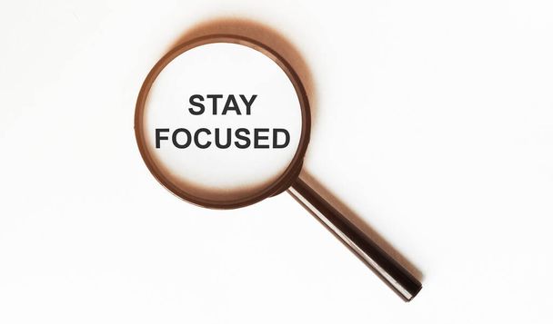 Stay Focused on a sheet under a magnifying glass - Photo, Image