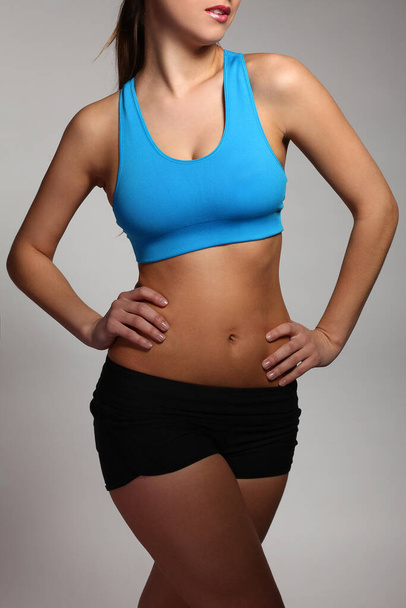 Beautiful caucasian woman's body in a fitness wear - Foto, immagini