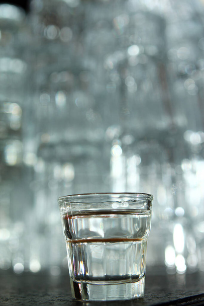 Vodka in a little shot glass at the bar - Фото, зображення
