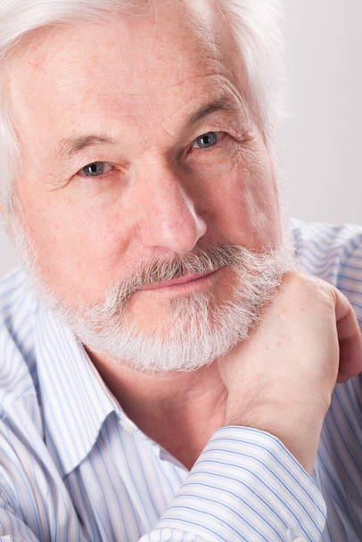 Handsome elderly man with grey beard over background - Photo, Image