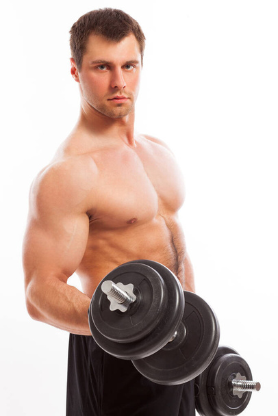 Handsome guy working out with dumbbells isolated over white background - Фото, зображення