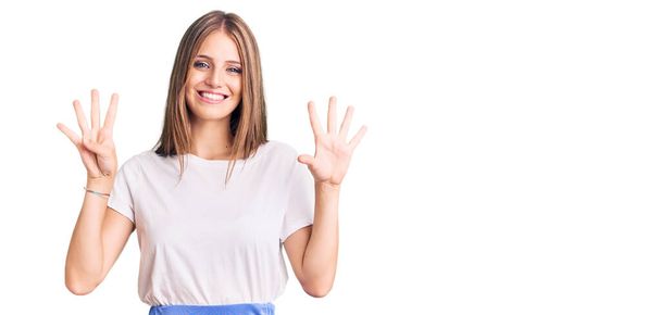 Young beautiful blonde woman wearing summer style showing and pointing up with fingers number nine while smiling confident and happy.  - Foto, imagen