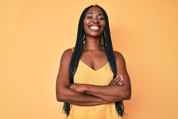 African american woman with braids wearing casual clothes happy face smiling with crossed arms looking at the camera. positive person.  - Foto, Bild