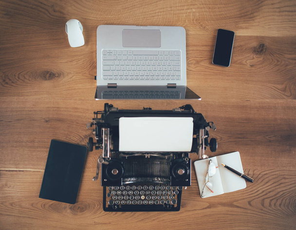 new laptop and old typewriter on wooden table - Фото, зображення