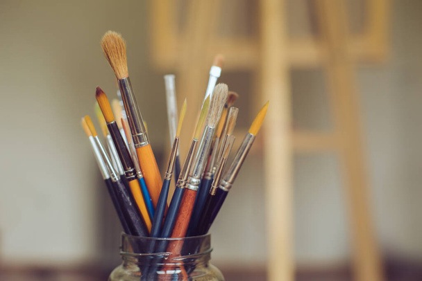 Paintbrushes in a jar at artist's studio - Photo, Image
