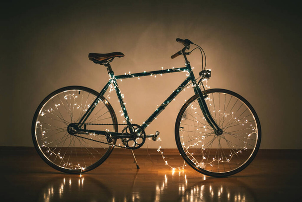 Christmas bicycle. Bike decorated with christmas lights - 写真・画像
