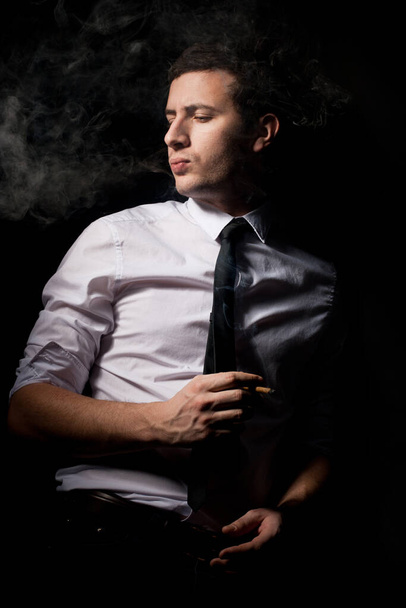 Portrait of man smoking cigarette - Zdjęcie, obraz