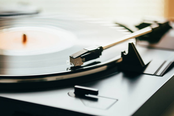 Turntable with vinyl record playing music. Vinyl record on gramophone - Photo, Image