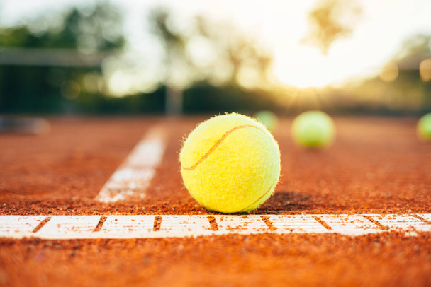 Tennis ball on tennis court. Tennis ball on baseline of tennis court - Photo, Image