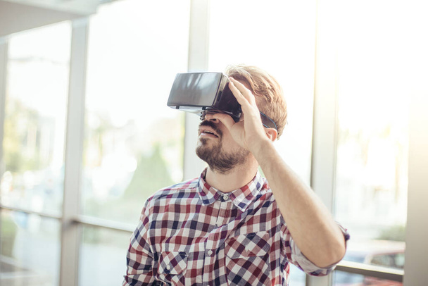 Young guy in viar glasses, man plays with virtual reality glasses - Fotoğraf, Görsel