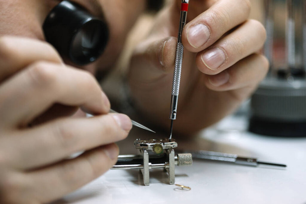 Watchmaker is repairing the wristwatch, mechanical watch - Фото, зображення