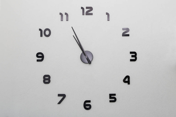 A large modern clock on a wall in the house - Photo, image
