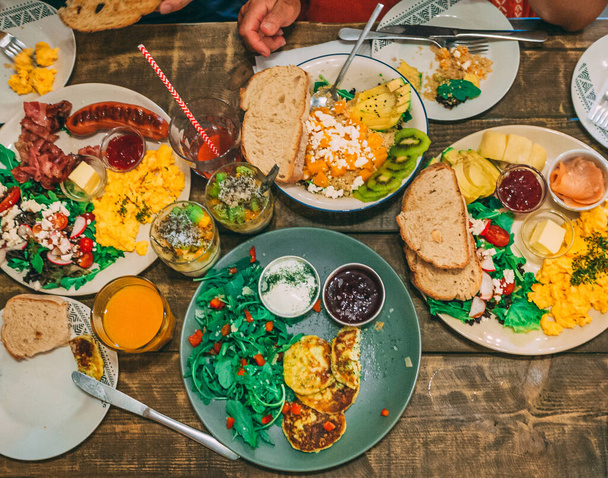 A high angle shot of a table of delicious dishes and drinks - Valokuva, kuva