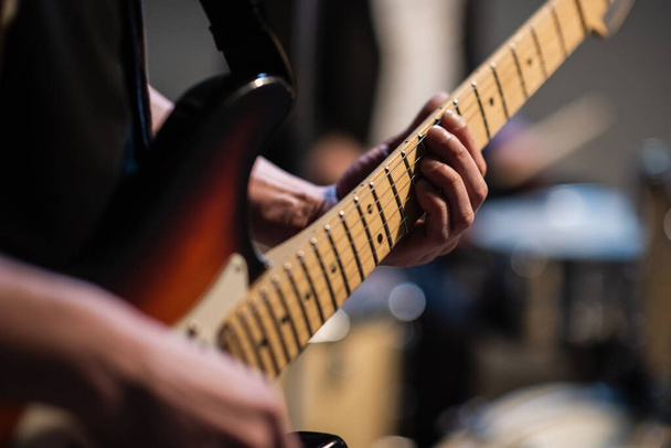 close-up of the hands of a musician playing an electric solo guitar in the Studio. - Photo, Image