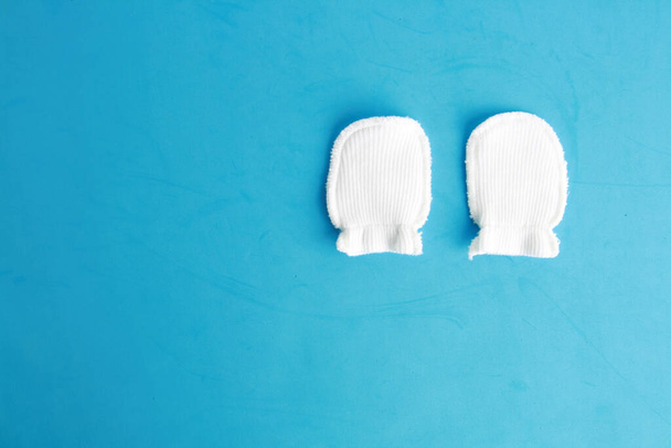 An overhead shot of white wool mittens for baby - 写真・画像