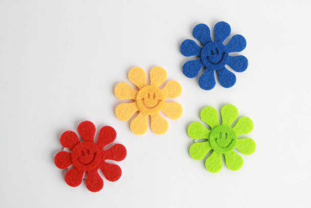 A closeup shot of colorful flowers with a smiley faces isolated on a white background - Foto, afbeelding