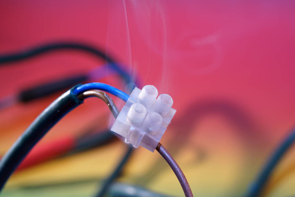 A selective focus shot of wires soldering on a colorful background - Valokuva, kuva