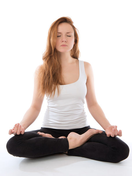 young woman meditating in yoga pose of lotus - Valokuva, kuva
