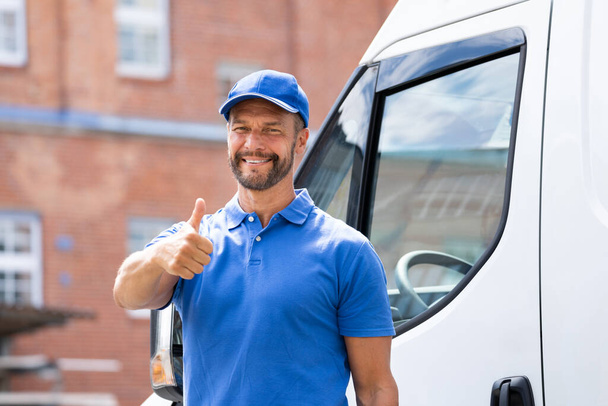 Smiling Delivery Men Or Handyman In Uniform Near Truck - Foto, immagini