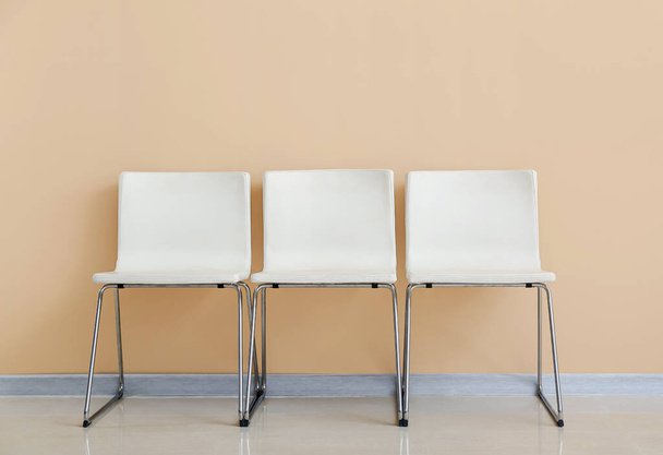 Modern chairs near color wall - Zdjęcie, obraz