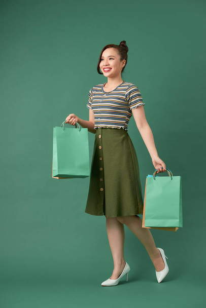カラフルなショッピングバッグを持つ魅力的な幸せな笑顔スタイリッシュな女性 - 写真・画像