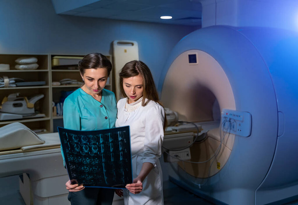 Modern tıp odasında bilgisayarlı tomografi ile röntgen taraması yapan kadın doktorlar.. - Fotoğraf, Görsel