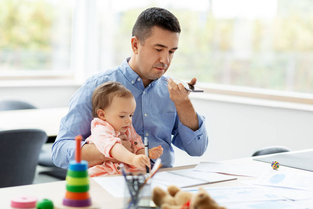 father with baby and phone working at home office - Fotoğraf, Görsel