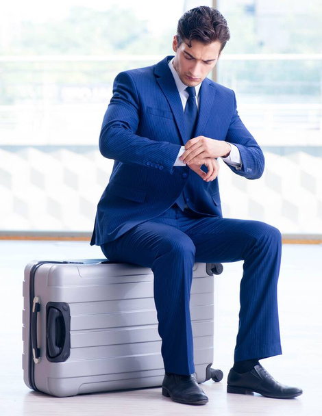 Biznesmen czeka na swój lot na lotnisku - Zdjęcie, obraz
