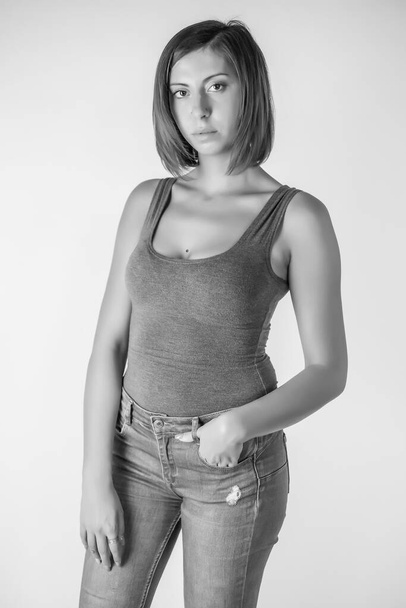 portrait of beautiful brunette girl with short hair and gray tank top. High quality photo - Фото, зображення