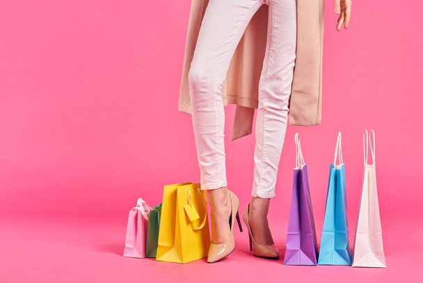 shopping bags female feet in shoes Shopaholic pink background - Photo, Image