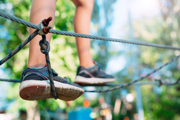 Rope Park. close - up of a childs feet passing an obstacle. - Φωτογραφία, εικόνα