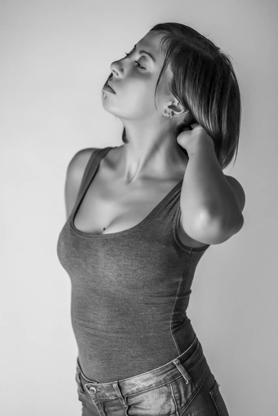portrait of beautiful brunette girl with short hair and gray tank top. High quality photo - Photo, Image