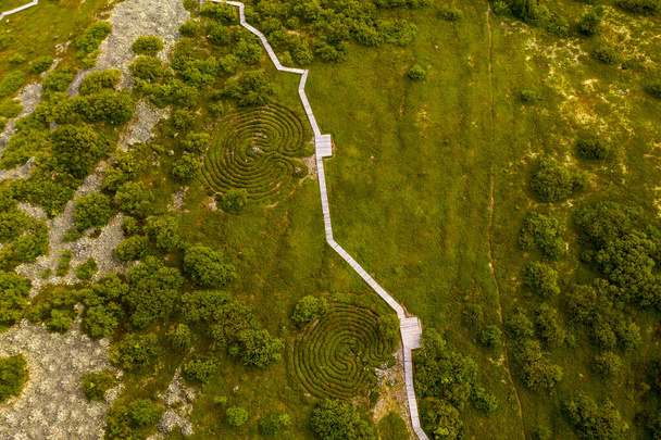 panoraamanäkymä asumattomalle saarelle, jolla on vanha kirkko ja muinaiset kiviset labyrintit kuvattuna lennokista - Valokuva, kuva