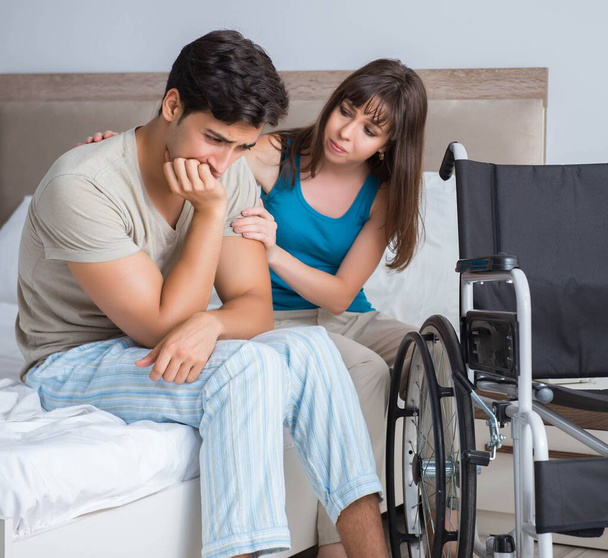 Zoufalý muž na invalidním vozíku se svou smutnou ženou - Fotografie, Obrázek