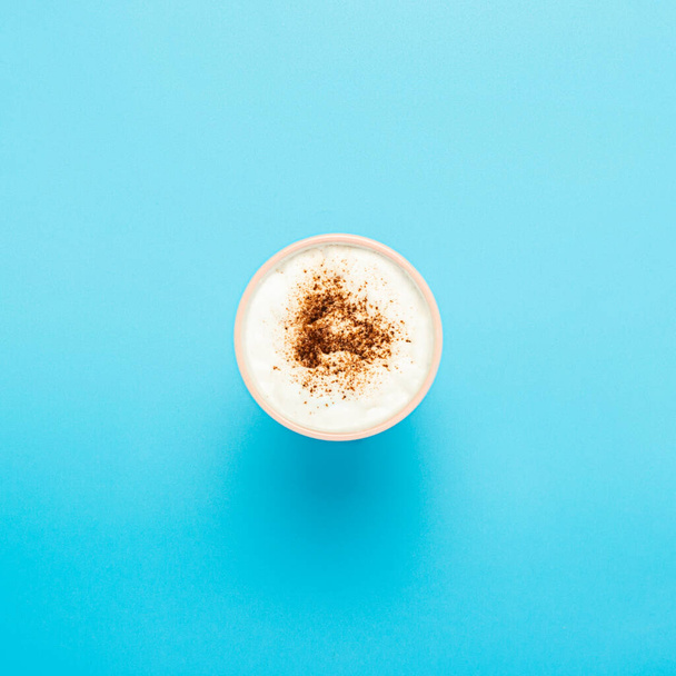 Cup with cappuccino, coffee with froth on a blue background. Concept coffee shop, barista, breakfast. Banner. Flat lay, top view. - Photo, Image