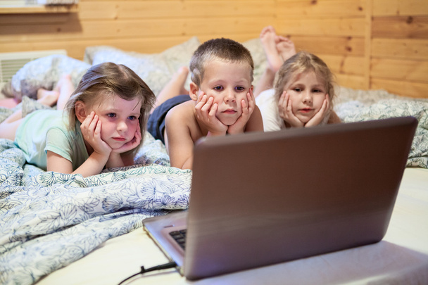 Three children looking at laptop - Photo, image