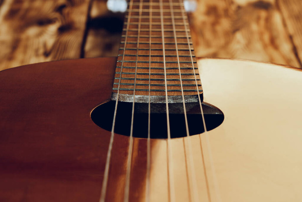 Wooden acoustic guitar body and fingerboard close up - Foto, Imagen