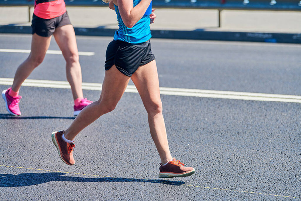 Running women. Sport women jogging in sportswear on city road. Healthy lifestyle, fitness hobby. Street marathon race, sprinting outdoor - Photo, Image