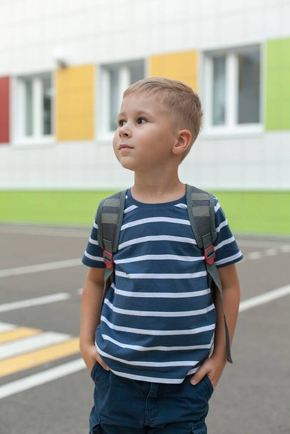 Happy cute smart boy with school bag. Modern backpack. First time at school. Back to school. - 写真・画像