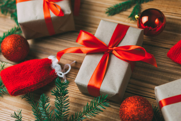 クリスマスカード。木の背景にモミの枝と休日の贈り物 - 写真・画像