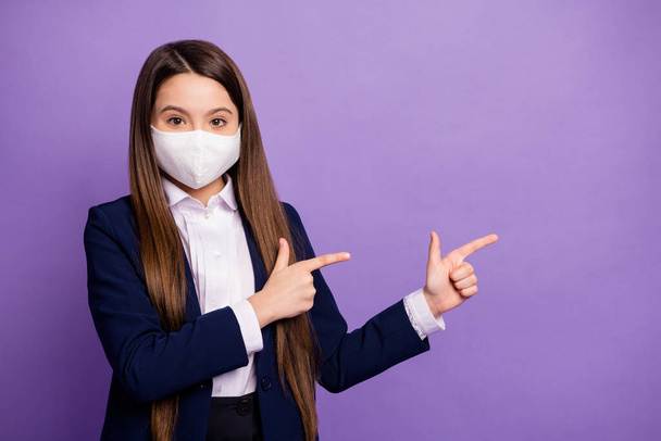 Portrait of nice small little long-haired girl wearing mask demonstrating copy empty blank space air pollution co2 environment isolated bright vivid shine vibrant lilac violet color background - Foto, imagen