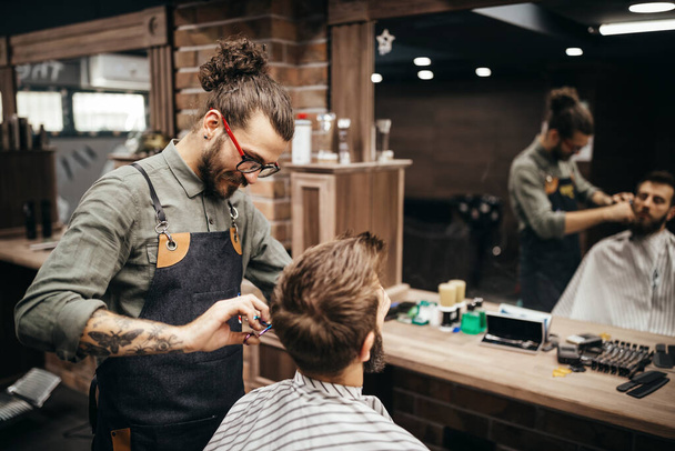 Man client during beard and mustache grooming in barber shop - 写真・画像