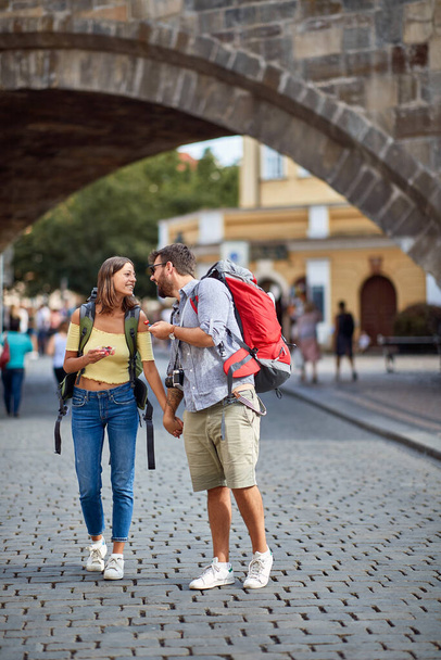 Young couple in love walking in the streets of Prague. Travel, tourism and people concept. - Fotoğraf, Görsel