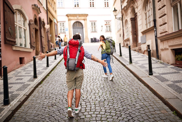 Happy women and men with backpack in love traveling together at Europe.   - Fotoğraf, Görsel