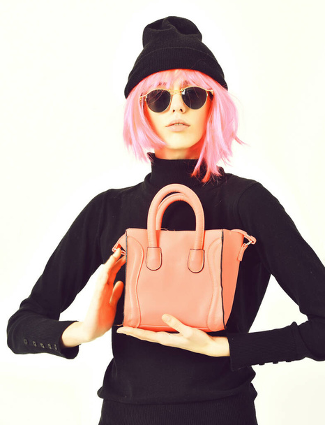 fashionable sexy girl in pink wig posing with fashion bag - Photo, image